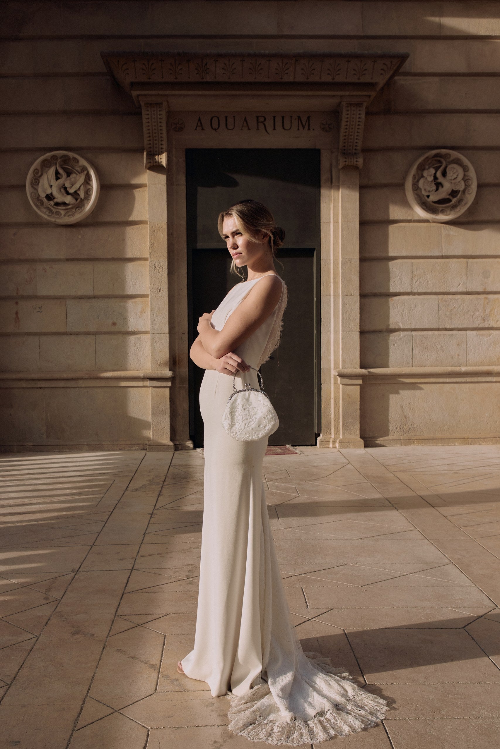 Photo plan large d'une femme montrant le petit sac à sequin pour mariée en extérieur