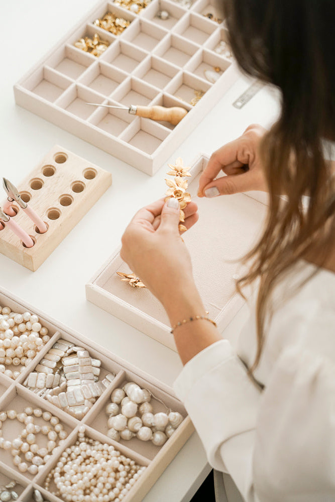 femme qui fabrique des bijoux de mariee avec des perles et des fleurs