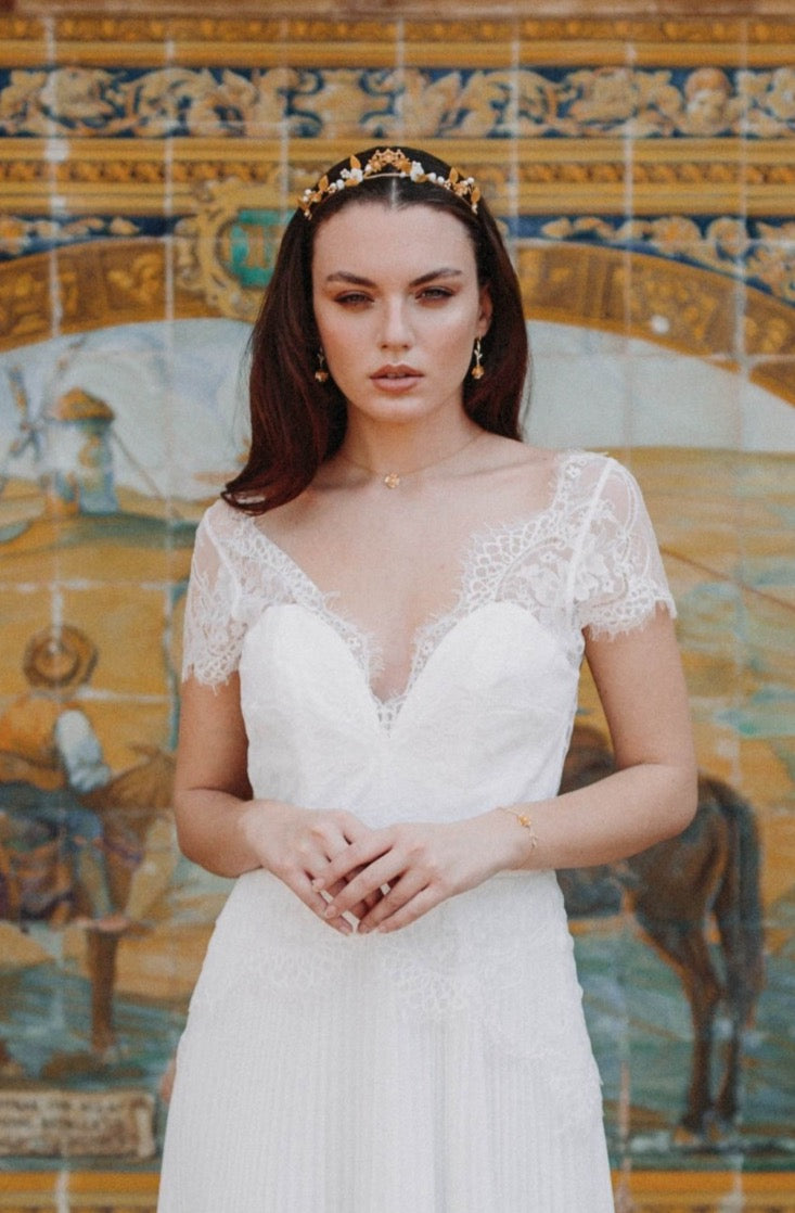 Mariée portant un couronne de fleurs dorées et un collier à fleur