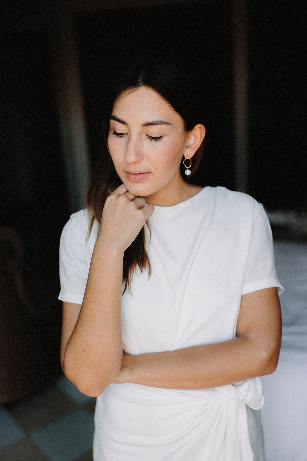 boucles d'oreilles minimaliste en forme de cercle imparfaite avec une perle naturelle portée par une mariée qui tourne la tête sur la gauche