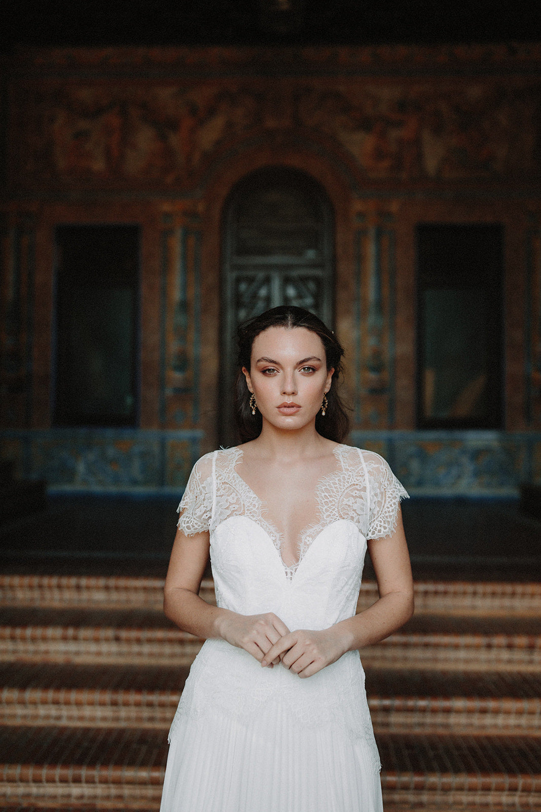Mariée avec robe de mariage et boucles d'oreilles pendantes fleuries