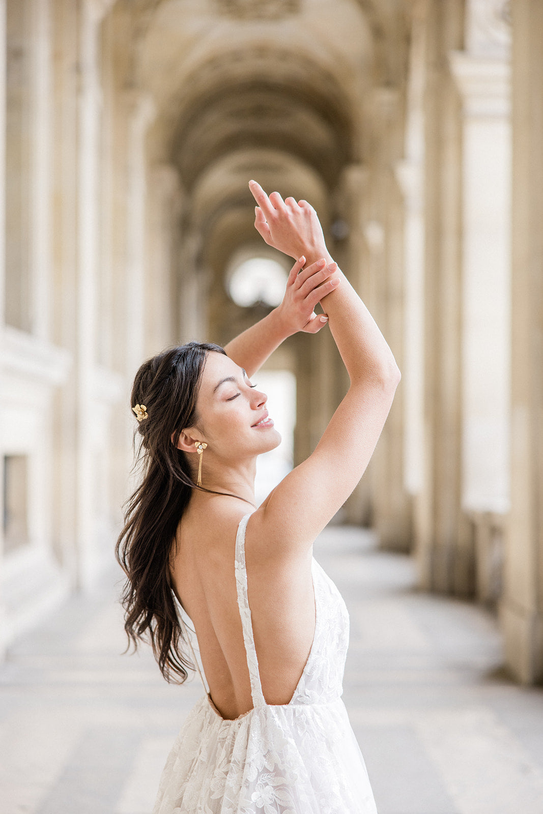 Mariée portant des boucles d'oreilles à fleurs dorées et pic à cheveux assorti