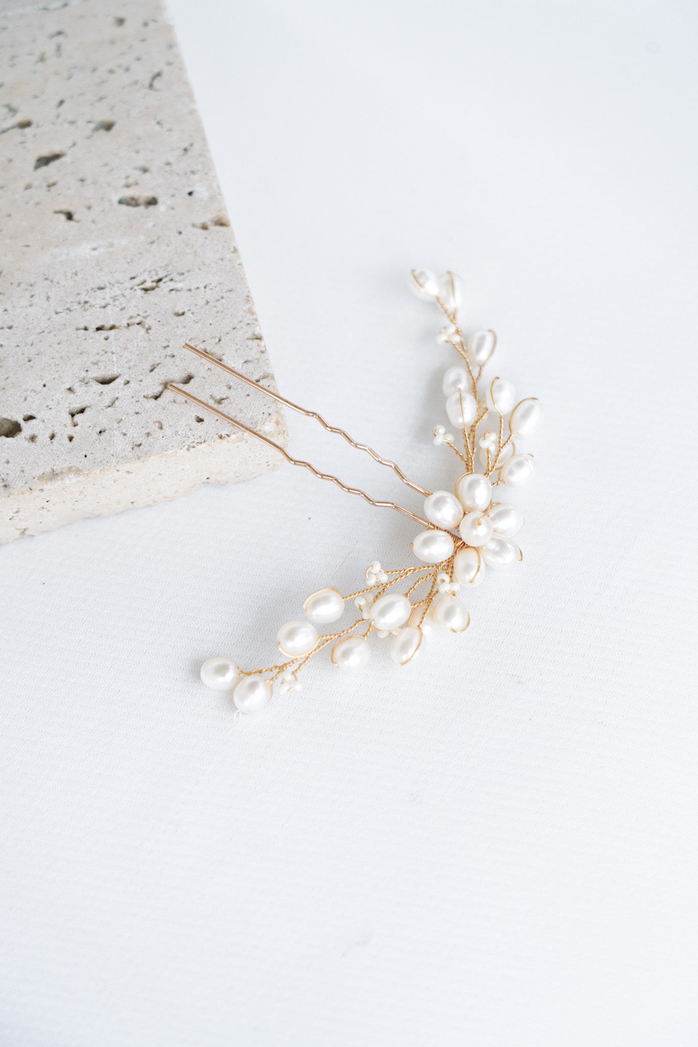pic de cheveux mariage formant un bouquet de perles relié par des fils dorés entrelacés