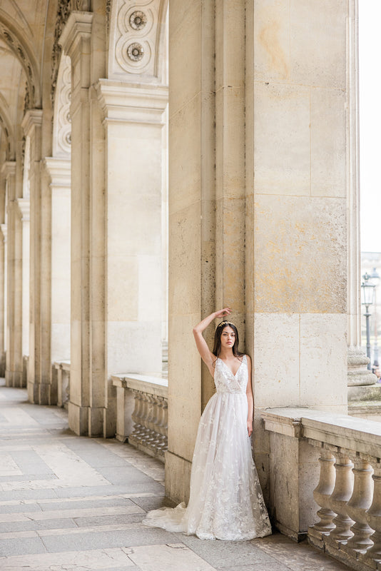 mariée à Paris dans une robe en dentelle posant avec le bras vers le haut et un couronne de fleurs en or 24k Atelier Lilac