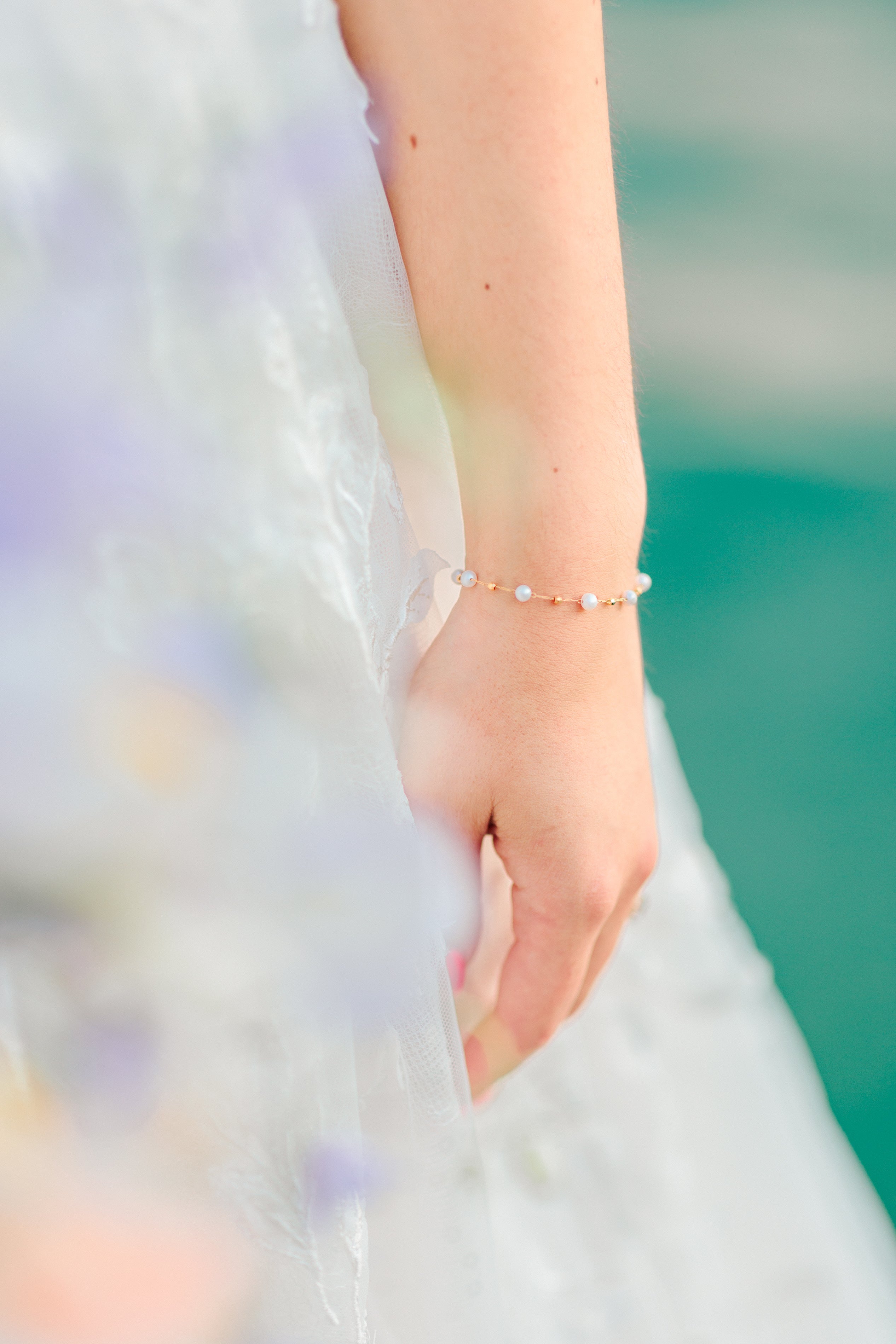 bracelet porté par une mariée sur la lac d'Annecy en robe de mariage à dentelle