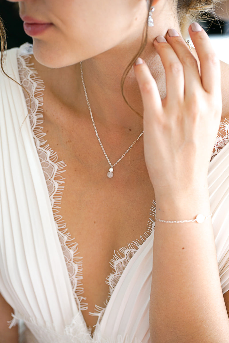 collier de mariage long porté par une mariée avec le bracelet assorti
