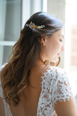 mariée en robe de mariée avec dentelle avec un dos nu et un pic floral dans les cheveux